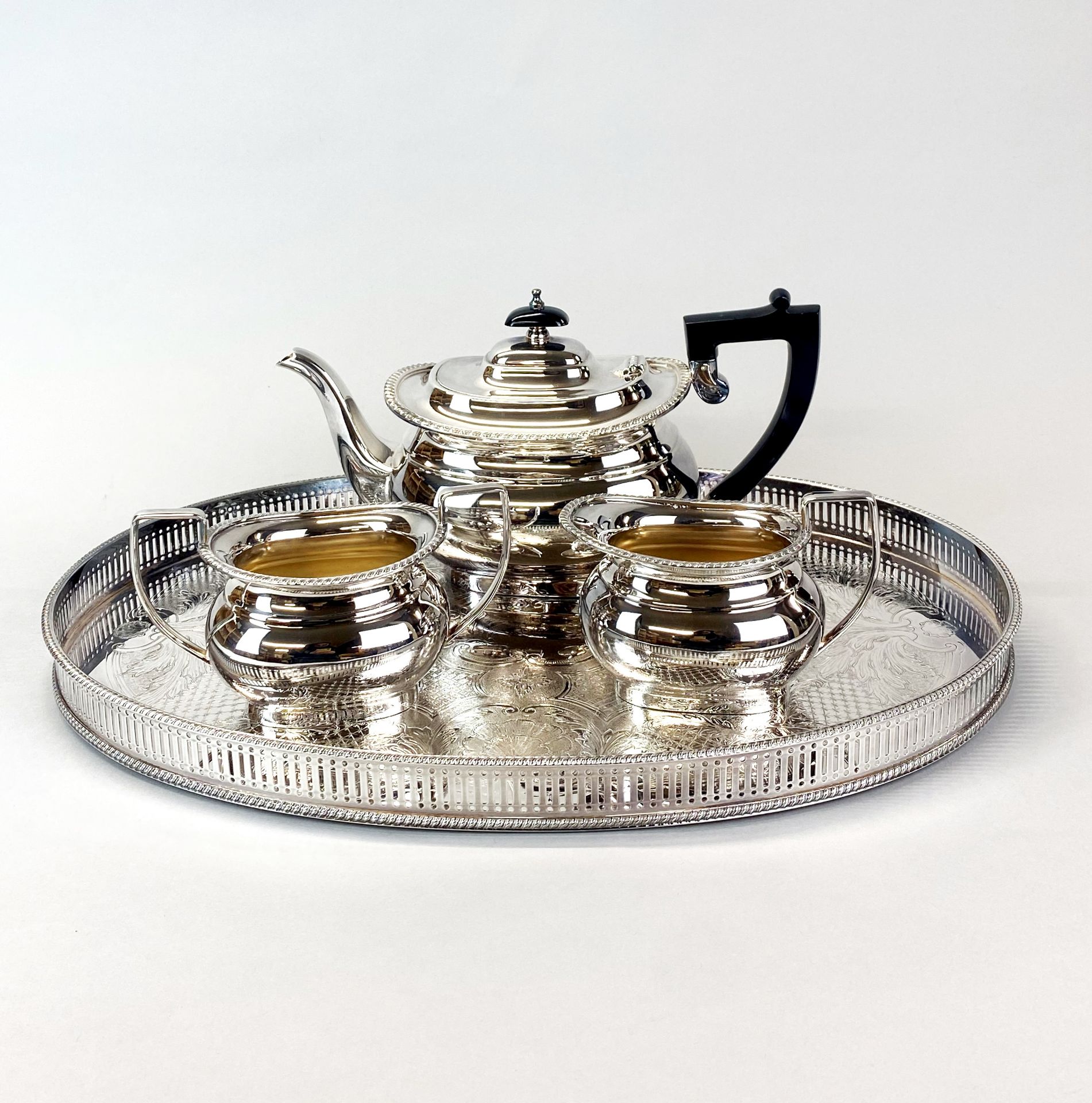 A Garrard and Co silver plated tea set and gallery tray.