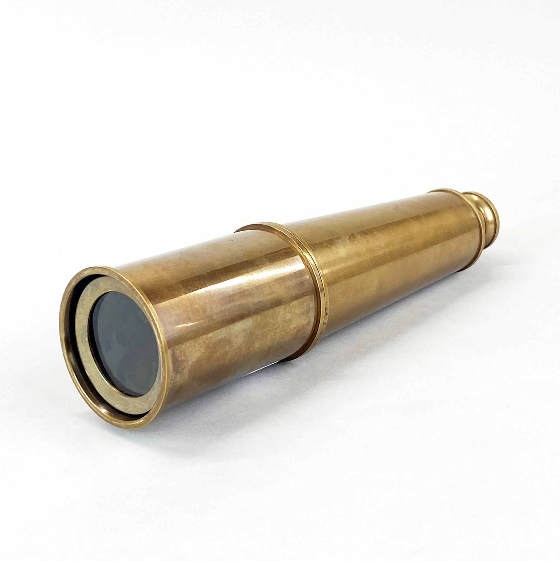 A brass telescope, closed L. 27cm.