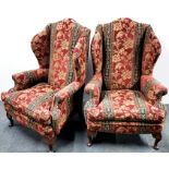 A pair of red and green upholstered wingback armchairs, H. 120cm.