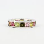 A 925 silver eternity ring set with multicoloured tourmalines, approx. 3.25ct total, (L). With