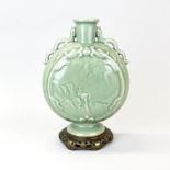 An ormolu mounted Chinese relief decorated and celadon glazed moon vase decorated with dragons and