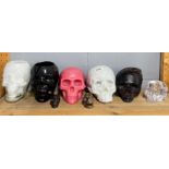 A group of ceramic, wax and glass skulls, tallest H. 18cm.