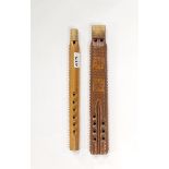 Two carved wooden flutes, longest L. 34cm.