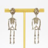 A pair of 14ct white gold (stamped 14K) skeleton shaped diamond set drop earrings, L. 5.5cm.