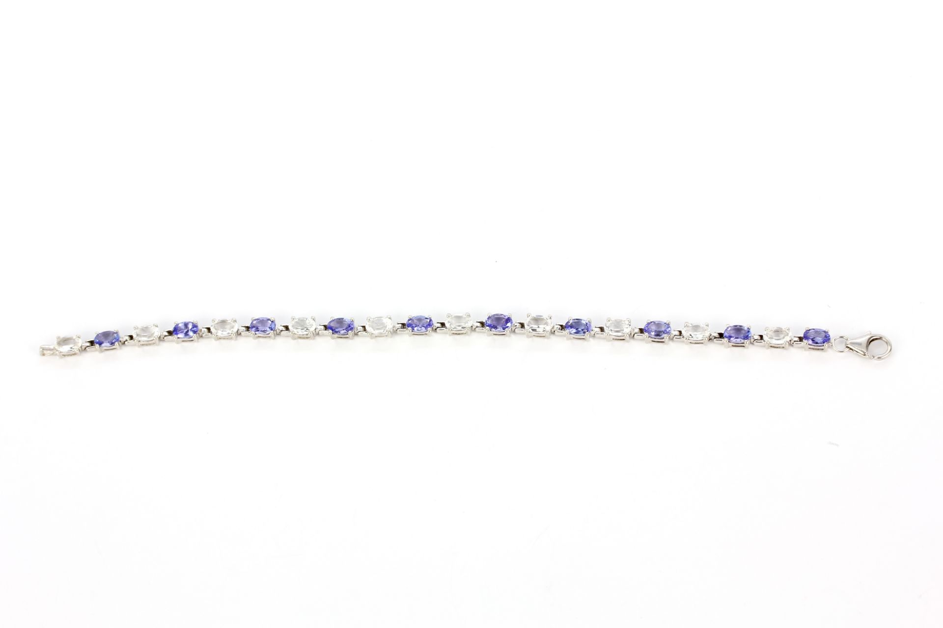 A 925 silver bracelet set with oval cut tanzanites and white topaz, L. 18.5cm. - Image 2 of 3