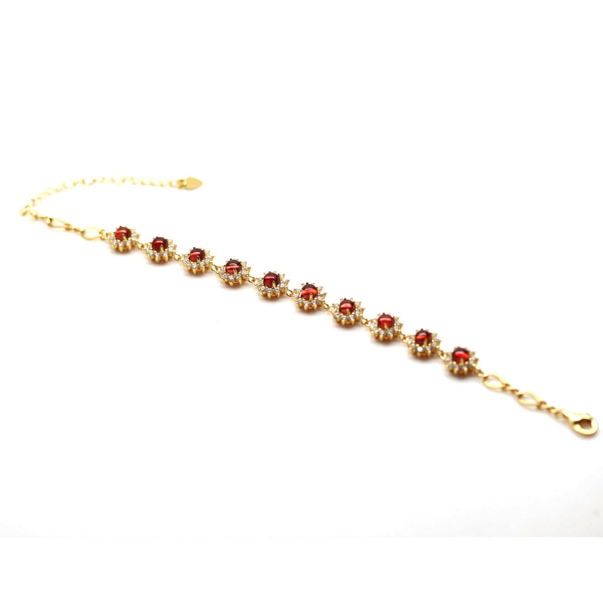 A 925 silver gilt bracelet set with cabochon cut garnets and white stones, L. 18cm. - Image 2 of 2