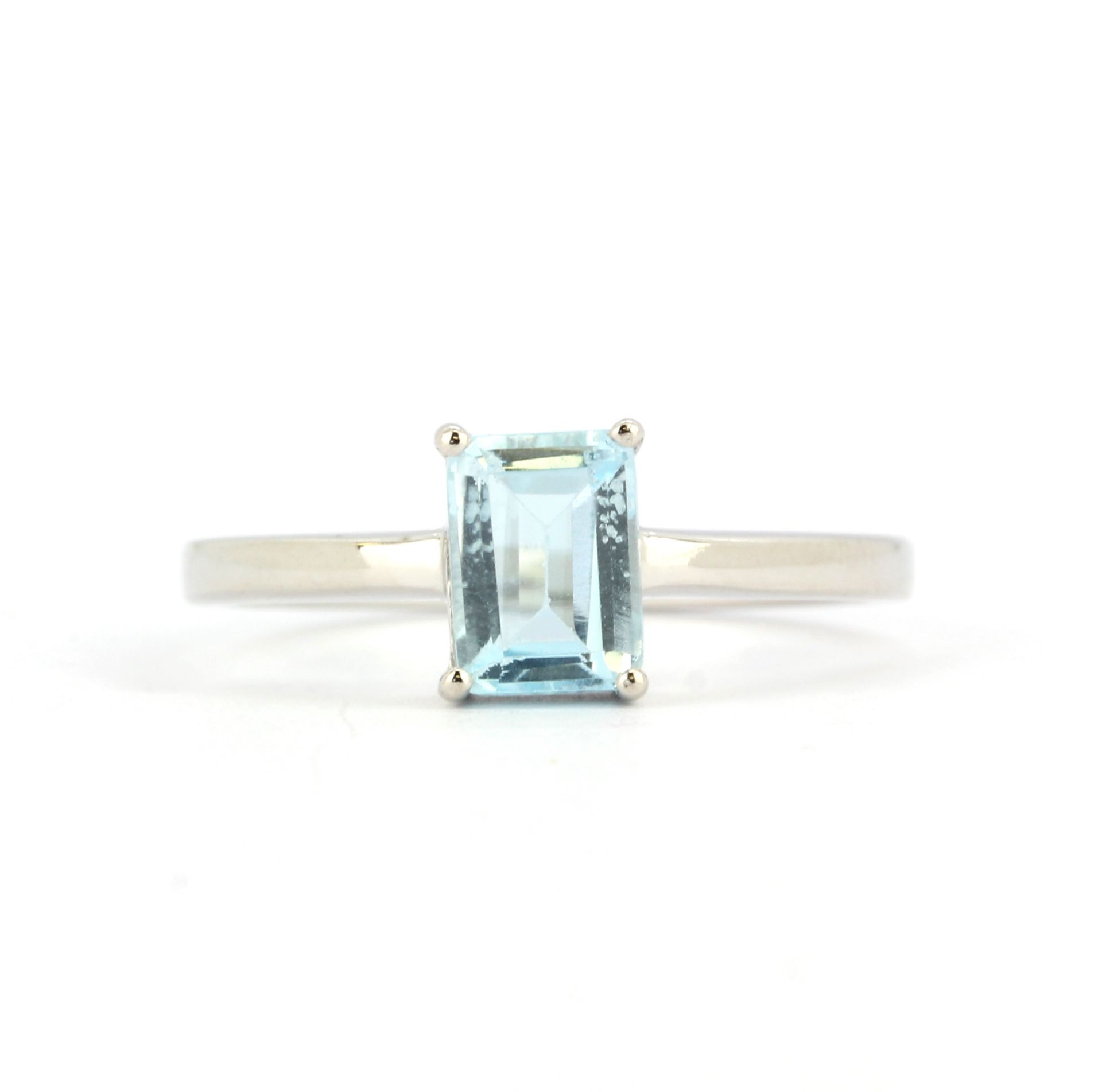 A 925 silver solitaire ring set with a baguette cut blue topaz, (O.5).
