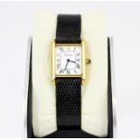 A Cartier 18k yellow gold electroplated wristwatch on an embossed black leather strap.