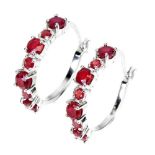 A pair of 925 silver hoop earrings set with round cut rubies, Dia. 2.3cm.