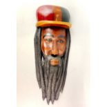 An interesting carved and stained hardwood mask of Bob Marley, H. 60cm.