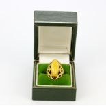 A 14ct yellow gold (stamped 14K) butterscotch amber set ring, (N).