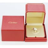 An unusual boxed 18ct white gold Cartier twist crossover design ring, (G).