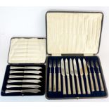 A cased set of hallmarked silver handles butter knives with a set of silver handles fruit knives and
