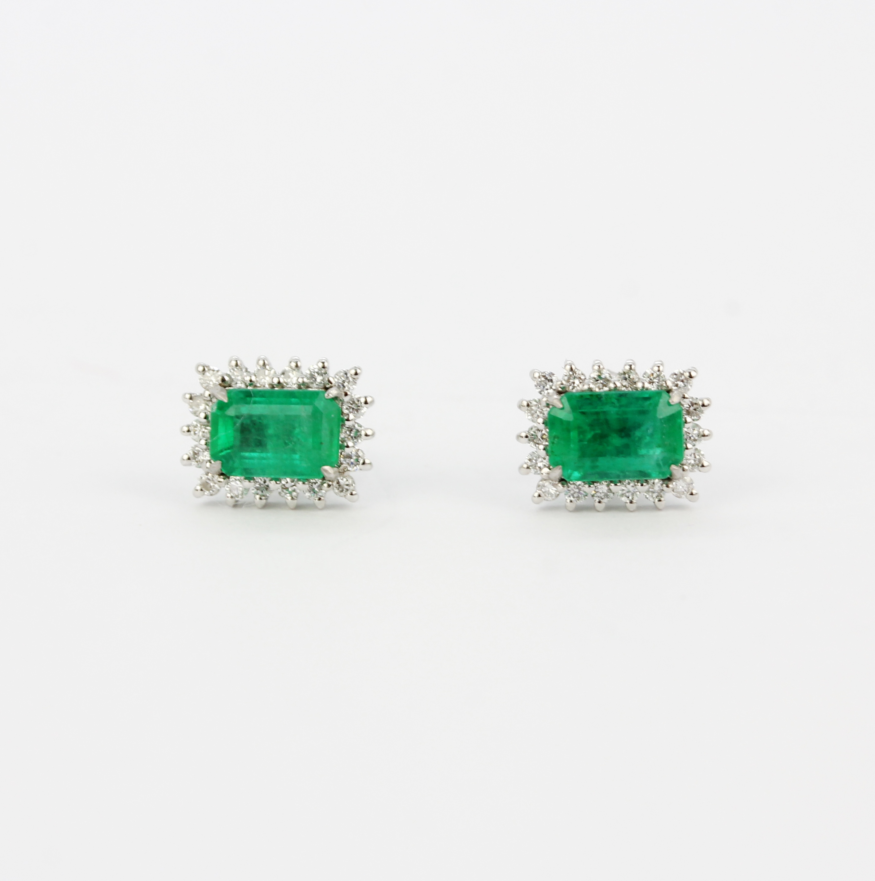 A pair of 18ct white gold stud earrings each set with an emerald cut emerald surrounded by brilliant - Image 3 of 4