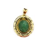 A large heavy hallmarked 18ct yellow gold pendant, L. 5cm, set with a large hand carved emerald,