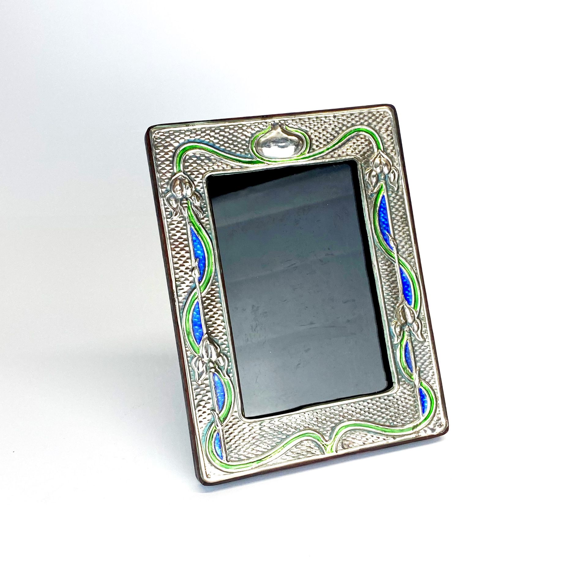 An Art Nouveau style sterling silver and enamel photo fame, 14.5 x 19cm.