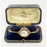 A lady's 1920's 9ct gold wristwatch on a 9ct gold expandable strap.