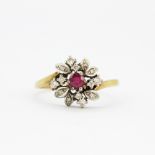 A 9ct yellow and white gold ring set with a round cut ruby and diamonds, (Q).