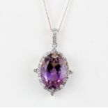 A 925 silver pendant set with an oval cut ametrine surrounded by white topaz on a silver chain, L.