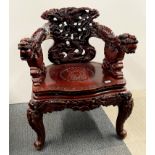 An ornately carved Chinese dragon chair, W. 68cm. H. 84cm. A small piece has detached from phoenix