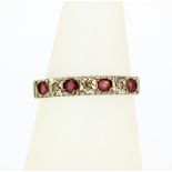 A hallmarked 9ct yellow gold ruby and diamond set ring, (N.5).
