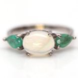 A 925 silver ring set with a cabochon cut opal and pear cut emeralds, (N).