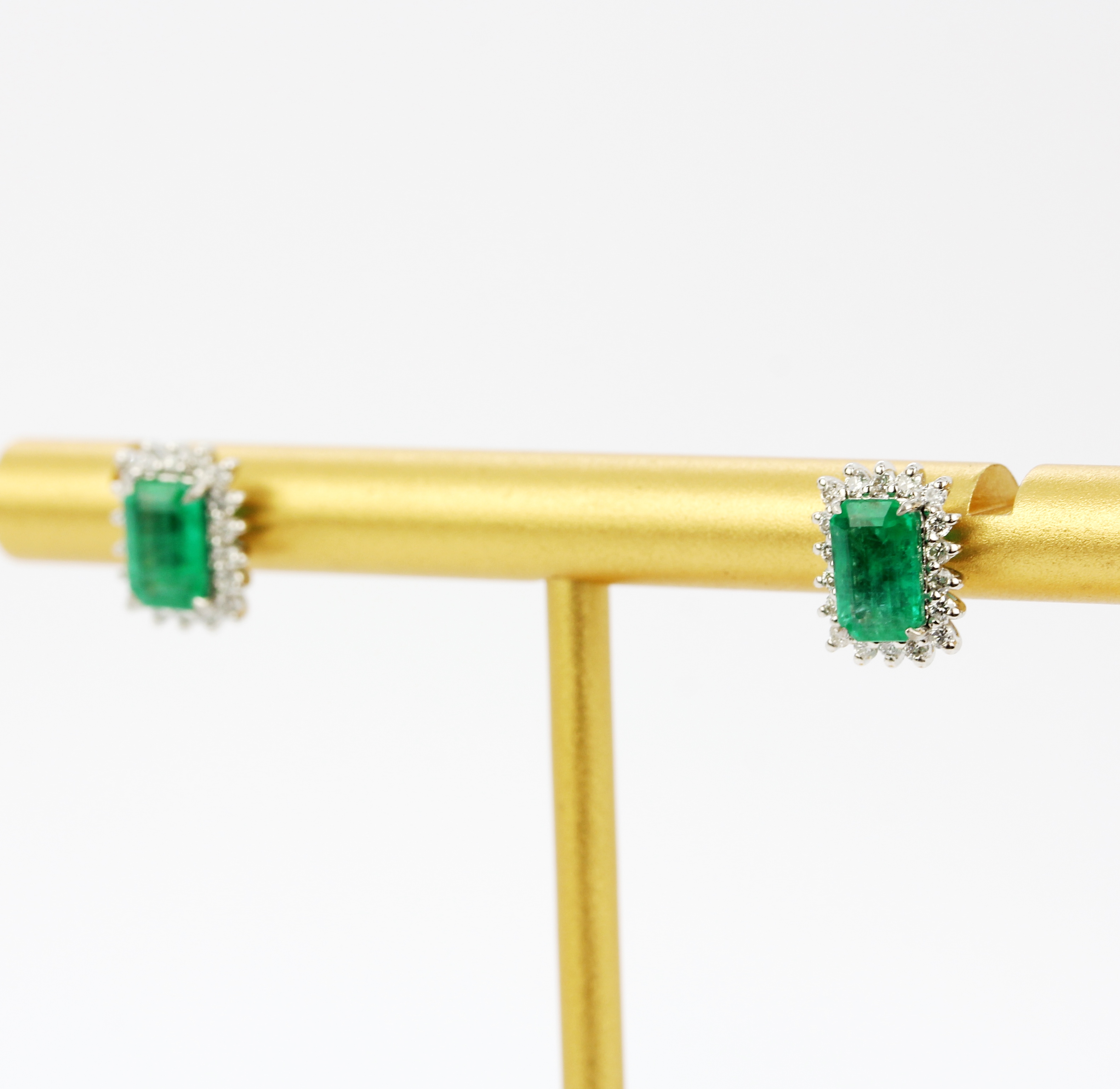 A pair of 18ct white gold stud earrings each set with an emerald cut emerald surrounded by brilliant - Image 2 of 4