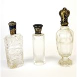 A group of three silver and cut crystal perfume bottles, tallest 10.5cm.