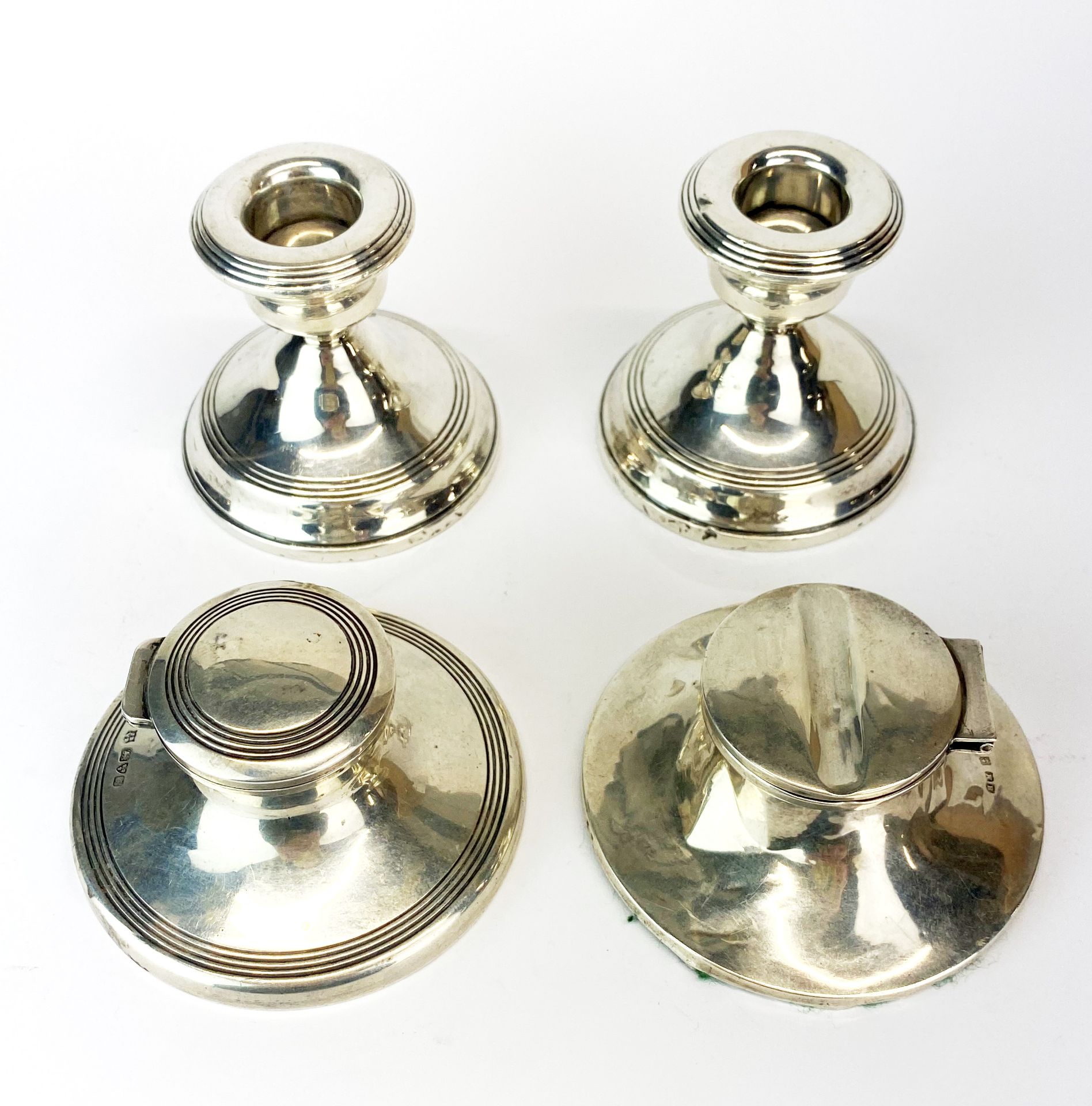 Two hallmarked silver ink wells, Birmingham c. 1912 and Chester c. 1909. Dia. 8.5cm. Together with a