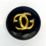 A vintage gilt metal and leather Gucci paperweight, Dia. 12cm.