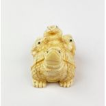 An Oriental signed carved bone figure of a tortoise and three frogs, L. 5.2cm. H. 3cm