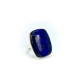 A 925 silver adjustable ring set with a large pear cabochon cut lapis lazuli.
