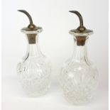 A pair of hallmarked silver topped cut crystal oil and vinegar bottles, H. 13cm.