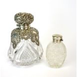 An ornate silver hallmarked silver and cut crystal dressing table bottle, Birmingham c. 1897. H.