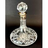 A cut crystal and hallmarked silver collar ships decanters, H. 25cm.