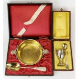 A boxed gilt lined W.M.F porringer and spoon together with a cased egg cup and spoon.