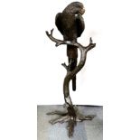 A heavy quality bronze sculpture of a parrot perched on a branch, H. 158cm.