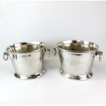 A pair of metal champagne advertising ice buckets, H. 24cm. W. 39cm.