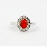 A 925 silver ring set with an oval cut fire opal, approx. 0.79ct, and small diamonds, (O). With