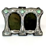 A small enamelled Art Nouveau style sterling silver and wood photo frame, 11 x8cm.