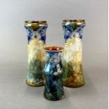 A pair of Royal Doulton stoneware vases together with a further similar stoneware vase, tallest.
