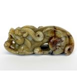 A Chinese carved jade / hardstone figure of a young dragon, L. 10.5cm. H. 4.4cm.