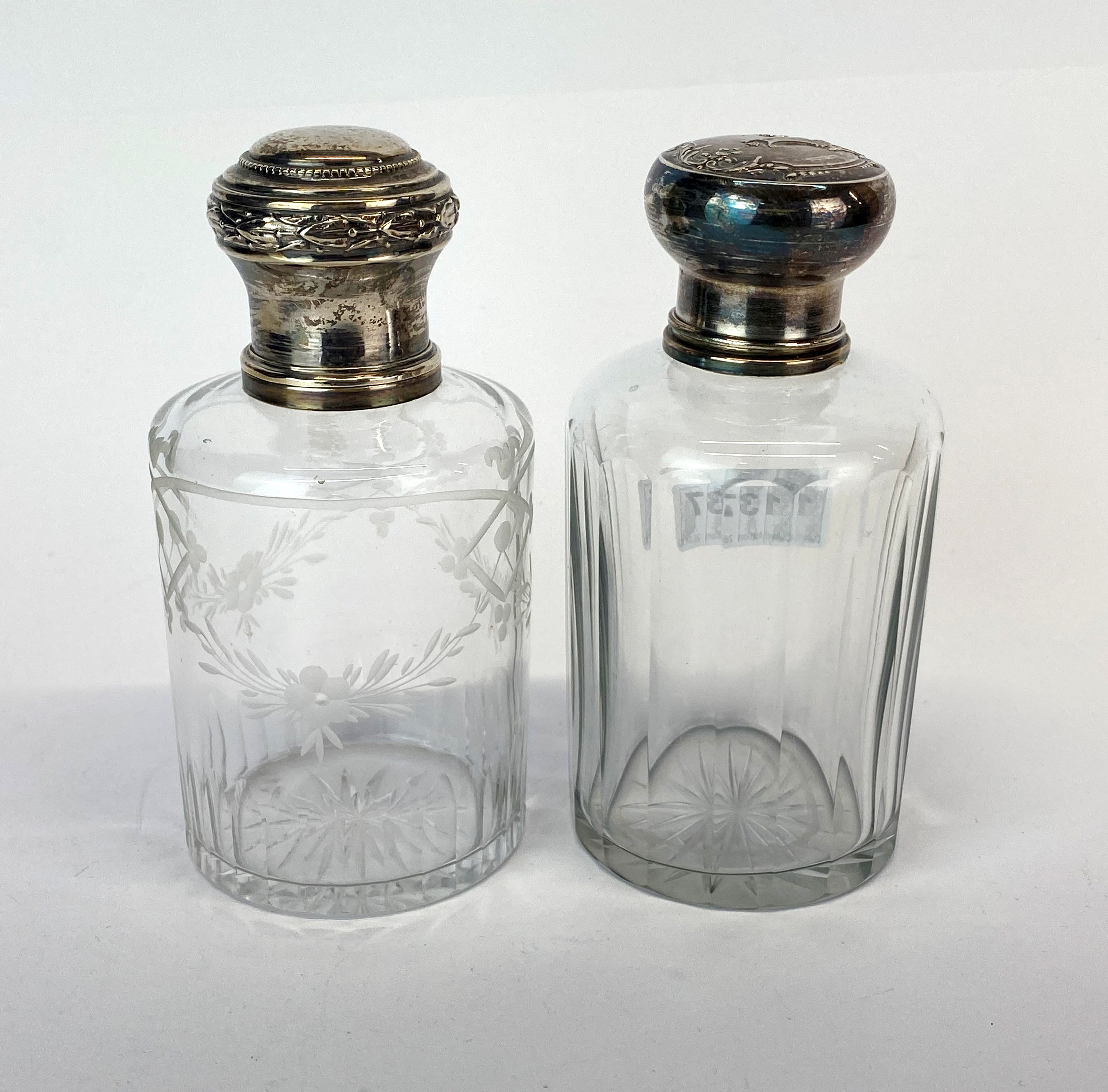 Two Continental silver topped dressing table bottles, H. 12cm.