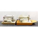 Two vintage sewing machines.