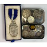 A Masonic silver medal and a small group of coins.