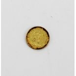 A gold Mexican Dos Pesos coin.