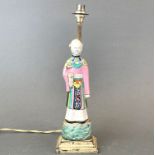 An 18th Century Chinese porcelain figure of a female attendant mounted in the 1920's as a table lamp