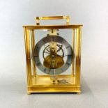 A gilt brass four glass skeleton clock by K. J. Bradford, H. 26cm. W. 18cm.