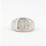 A gent's heavy 18ct (tested) white gold diamond set ring, (P).