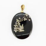 A large Victorian onyx pendant set with seed pearls, L. 5 x 4cm. One seed pearl missing.
